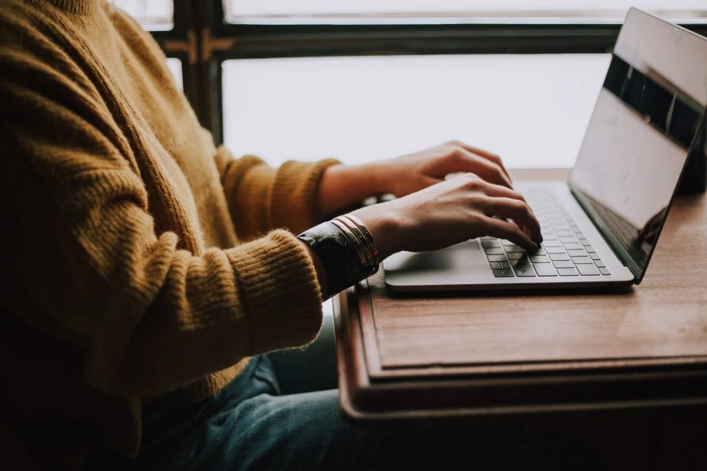 Person typing on a laptop.