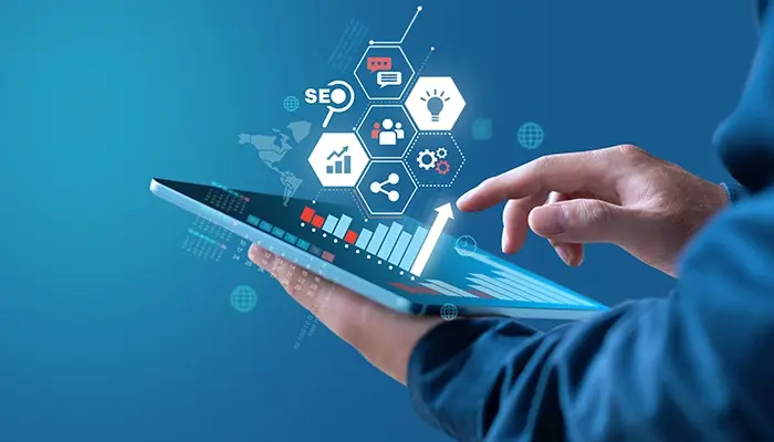 Finger tapping a tablet screen with graphic overlay of marketing symbols.