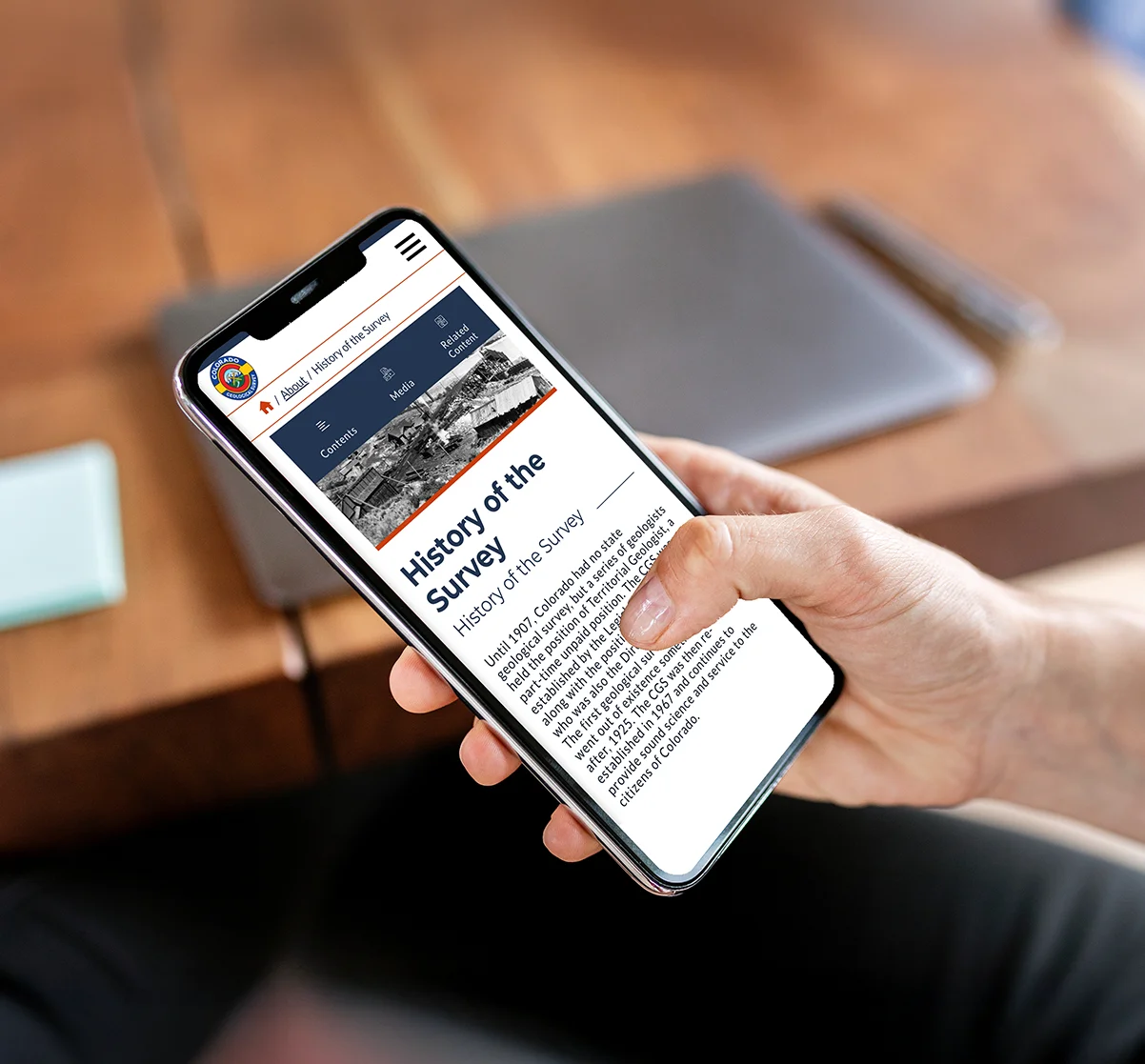 Researcher using a mobile device to explore CGS's Accessible responsive WordPress website.