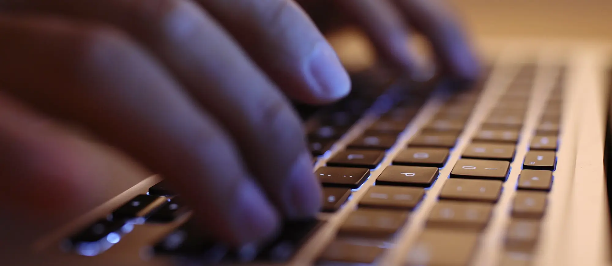 Closeup of fingers typing on a keyboard.