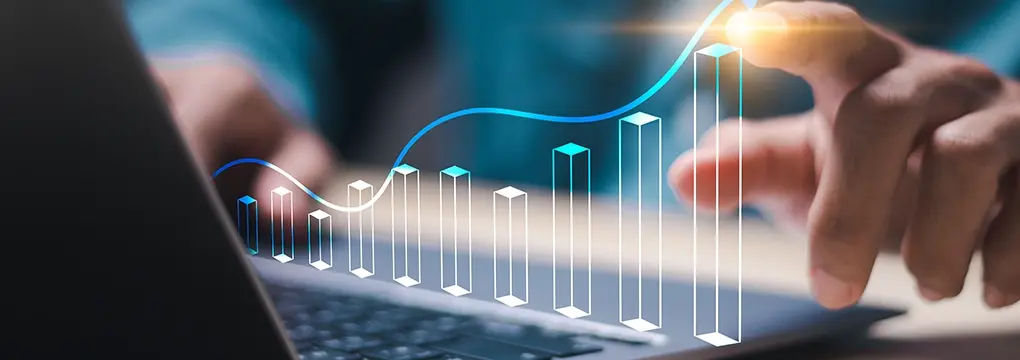 Abstract image of hands over a keyboard with a marketing growth chart over top.