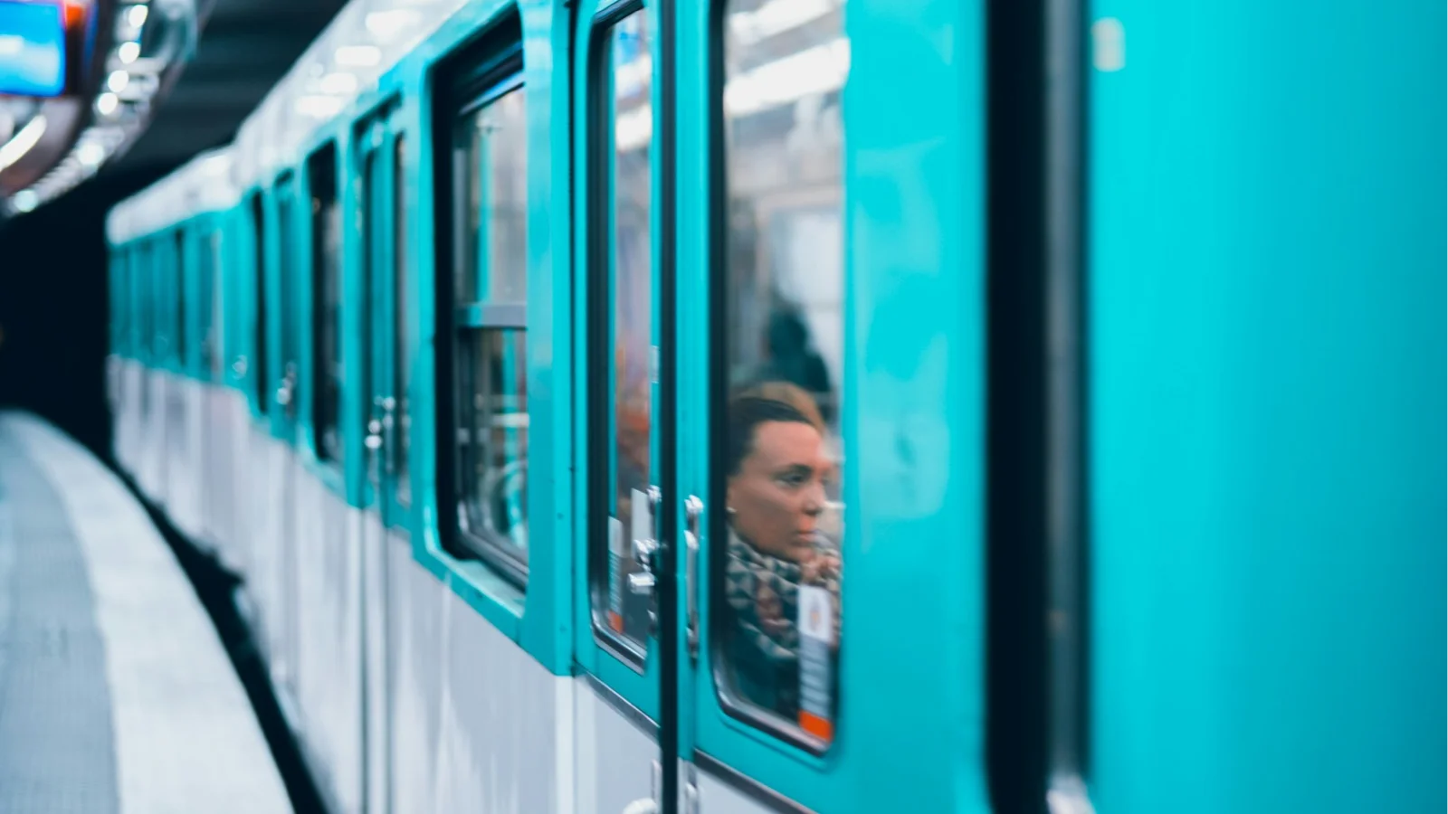 Picture of a subway train and a woman visible through the train window - like train departures, the accessibility deadline is coming April 2026.