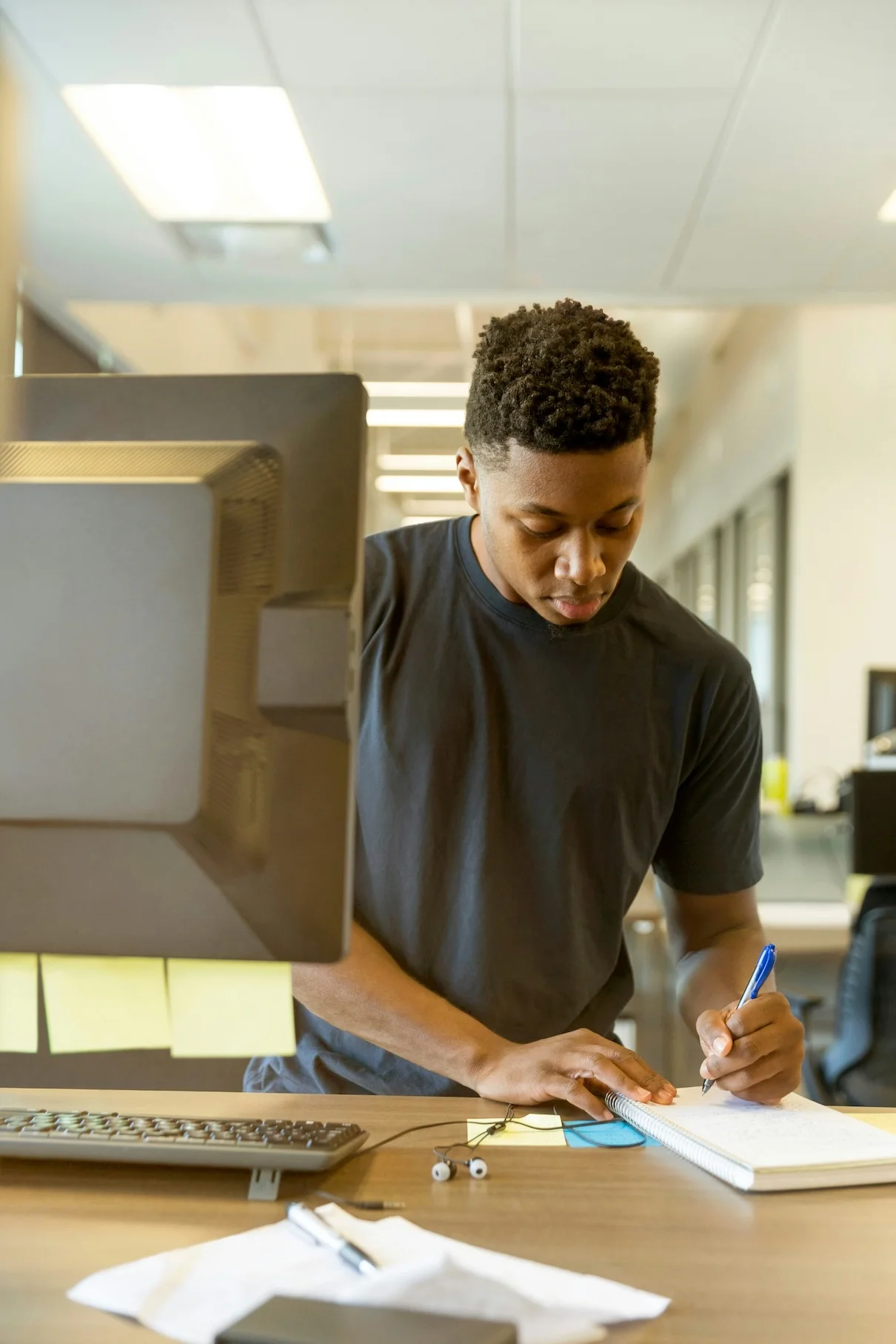 College student working on a computer in university setting.